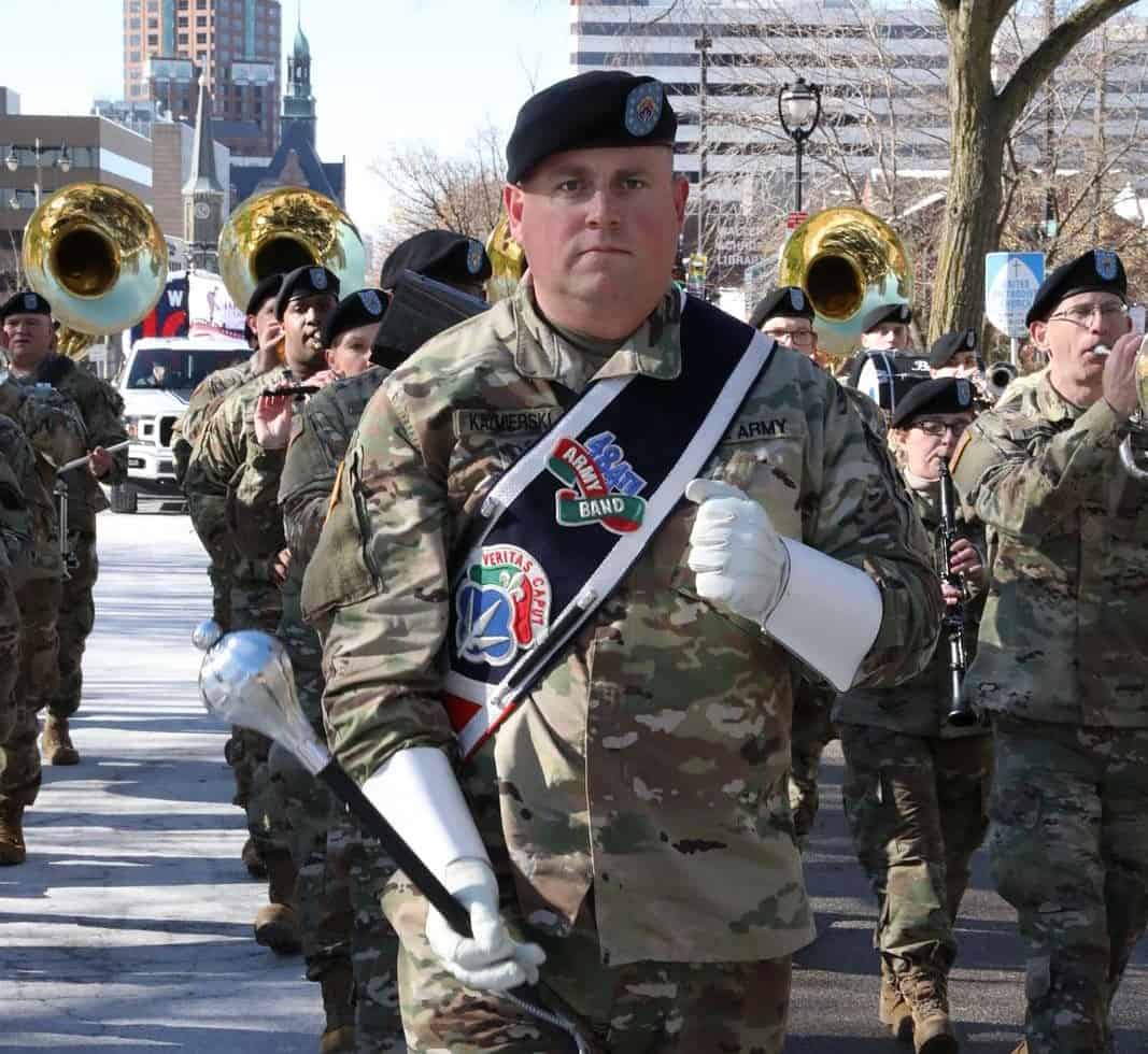 Staff Sergeant Jeff Kazmierski, 484th Army Band, leads a former Vets Day Parade; image for a Veterans Day 2022 blog post